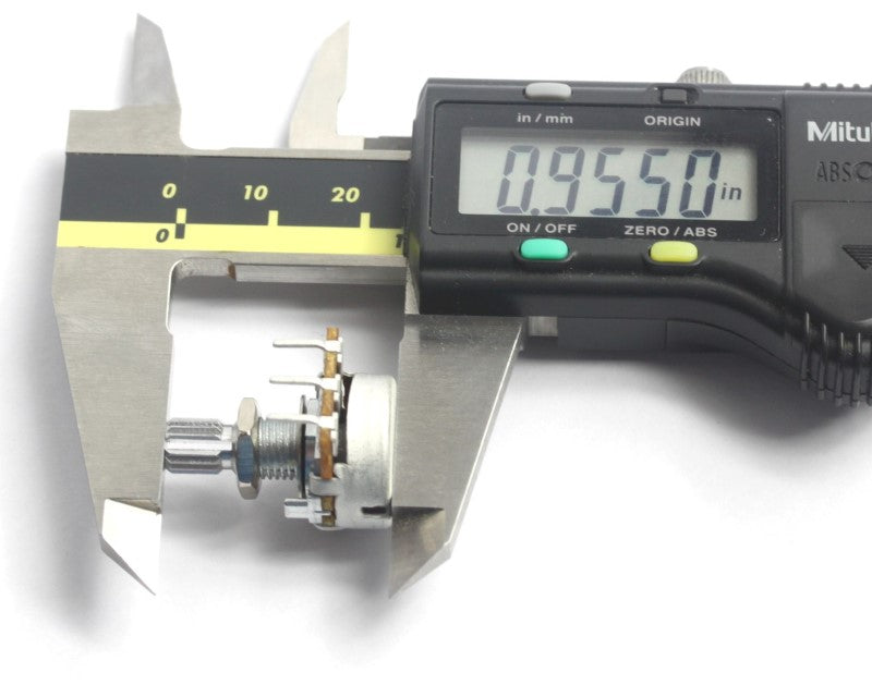 A caliper holding a 5K potentiometer showing a measurement of .9550 inches.