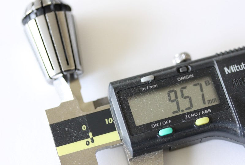 3/8 ER20 Collet shown with the inside measured on a caliper. The measurement from the caliper reads 9.57mm.