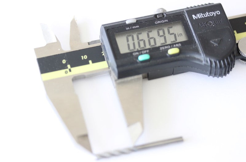 1/8" four flute end mill shown with a caliper. The measurement reads .6695 inches.