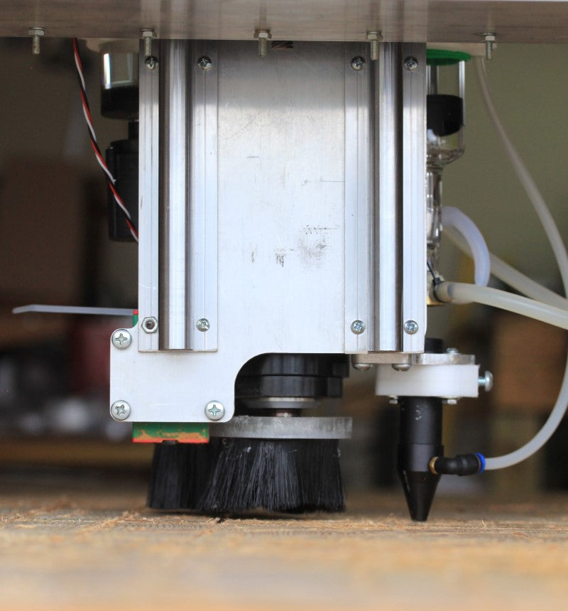 Fabricator Pro CNC Router View of the back of the z axis showing the CO2 LAser Nozzle, bottom of the spindle and the Dust Shoe