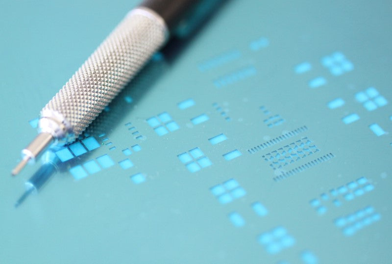 up close shot of stencil with mechanical pencil shown for scale 