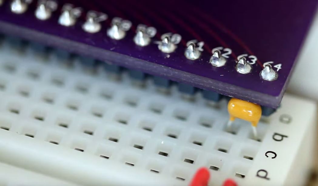 Image show the .1 uf capacitor connected between pins 63 and 64